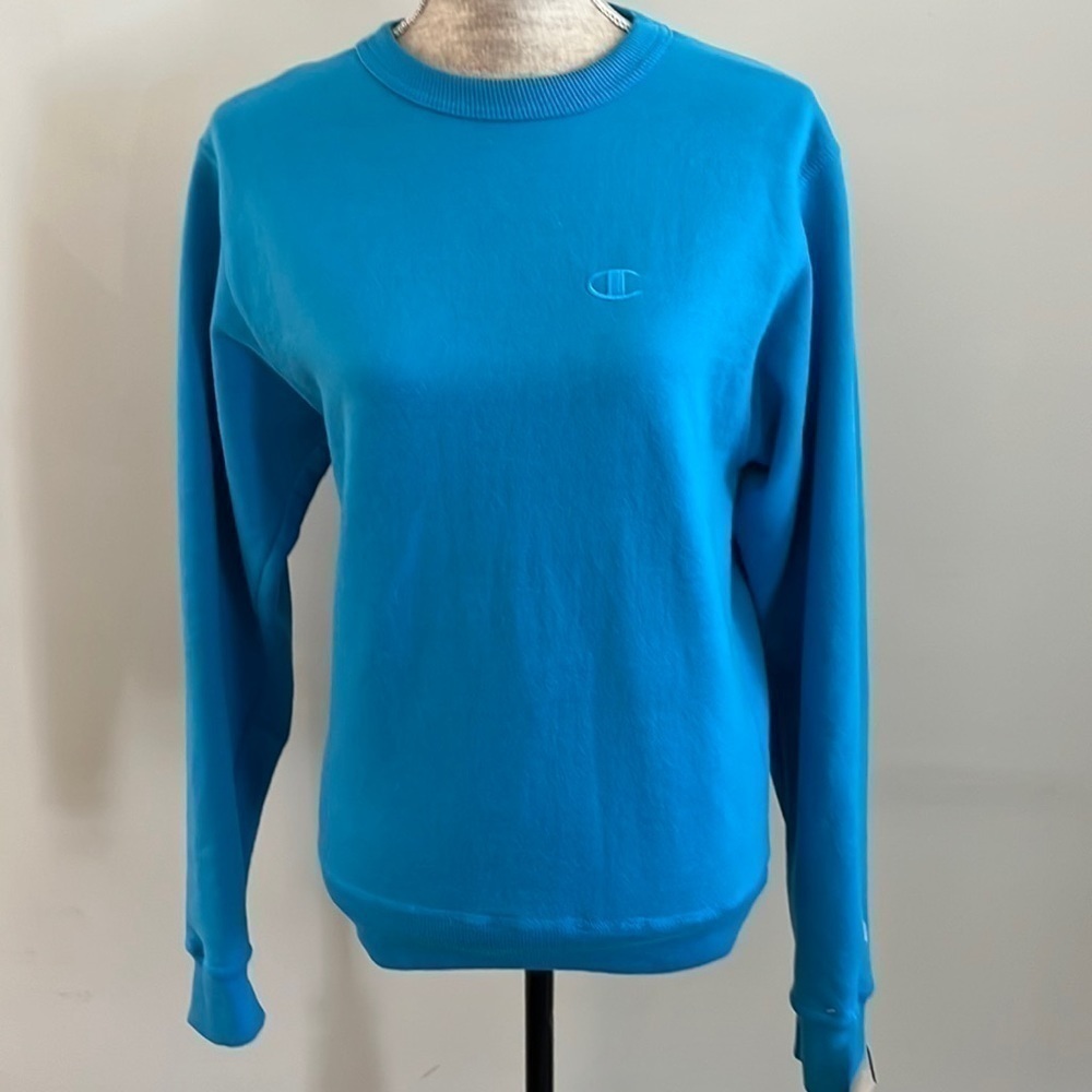 Turquoise Champion sweatshirt size extra small.  Unisex item.